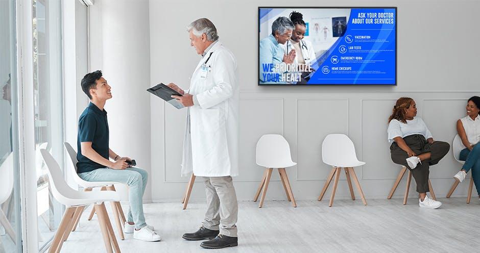 doctor and patients in a medical office waiting room with digital signage display